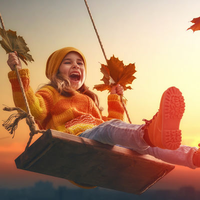 kid playing in the autumn