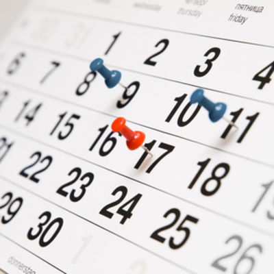 Closeup calendar page with drawing-pins